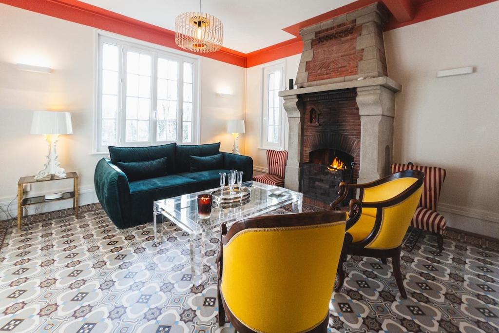 a living room with a couch and a fireplace at Villa Marguerite in Veulettes-sur-Mer