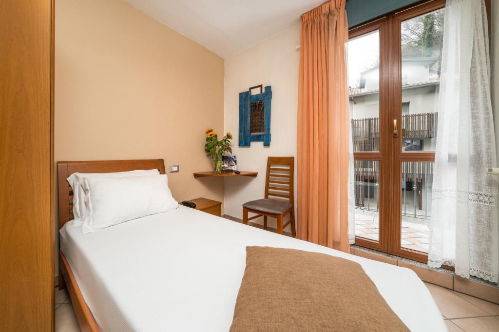 Postel nebo postele na pokoji v ubytování Hotel Oasi Verde