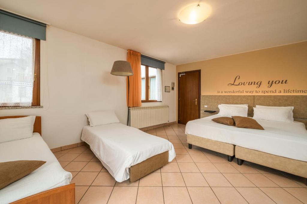 Postel nebo postele na pokoji v ubytování Hotel Oasi Verde