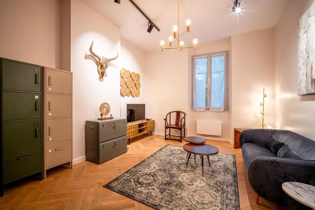 a living room with a couch and a table at OIQIA • Tolosa in Toulouse