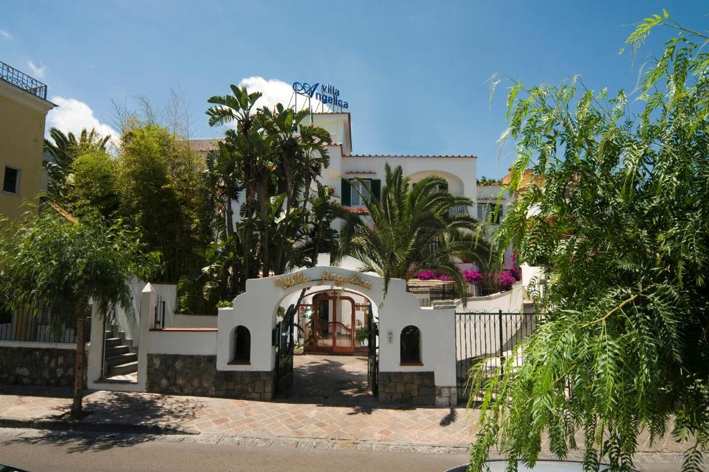 a white house with trees in front of it at Hotel Villa Angelica in Ischia