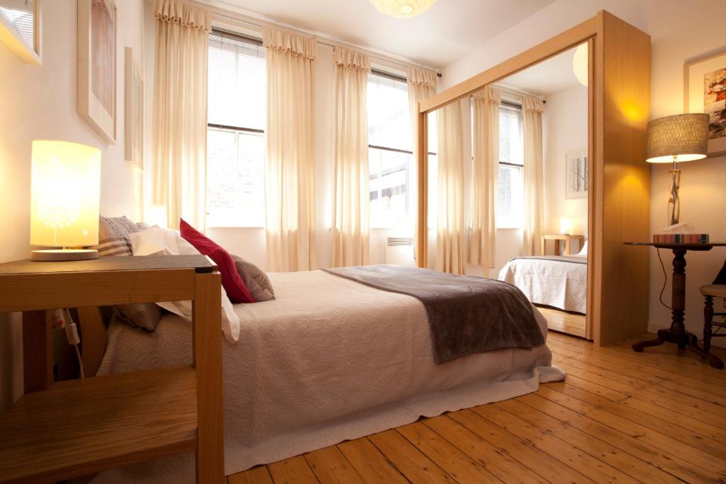 a bedroom with a bed and a large window at Urban Banana Apartments in Leeds