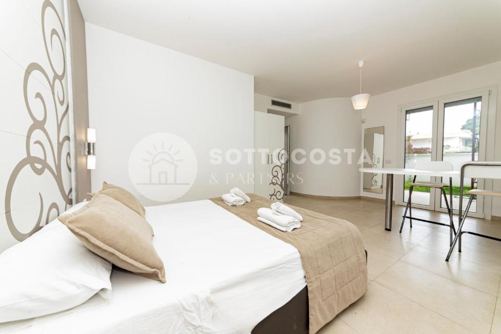 Łóżko lub łóżka w pokoju w obiekcie Ungaretti Resort