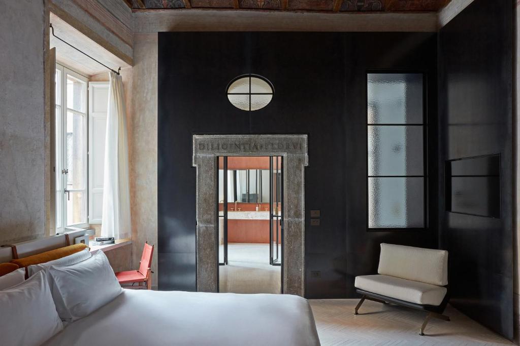 Postel nebo postele na pokoji v ubytování Palazzo Petrvs