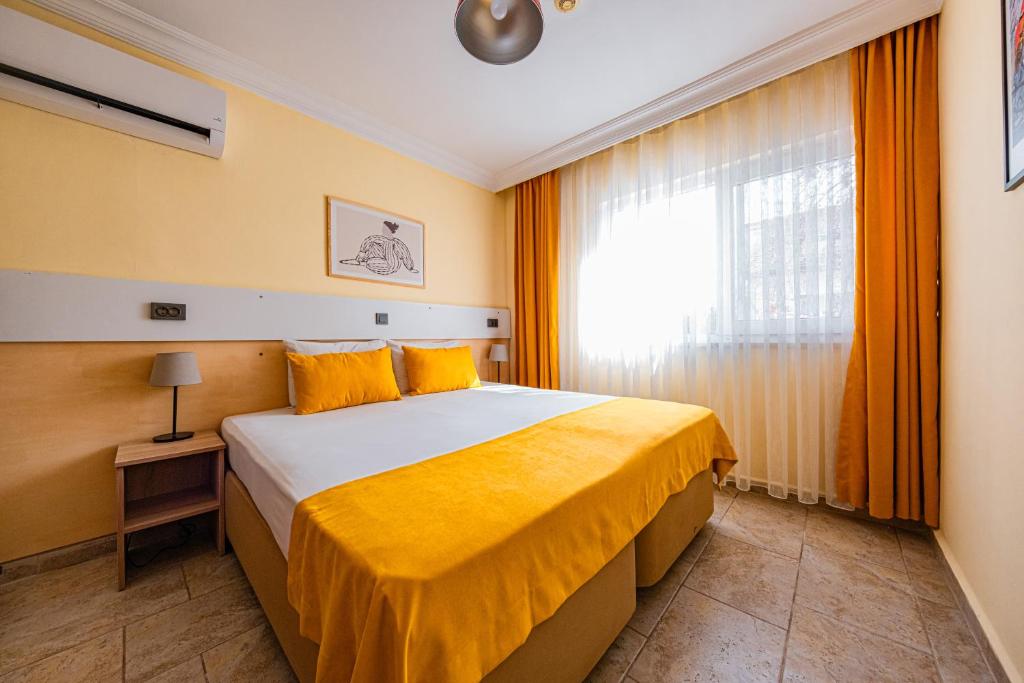 Postel nebo postele na pokoji v ubytování Ten Apart Hotel