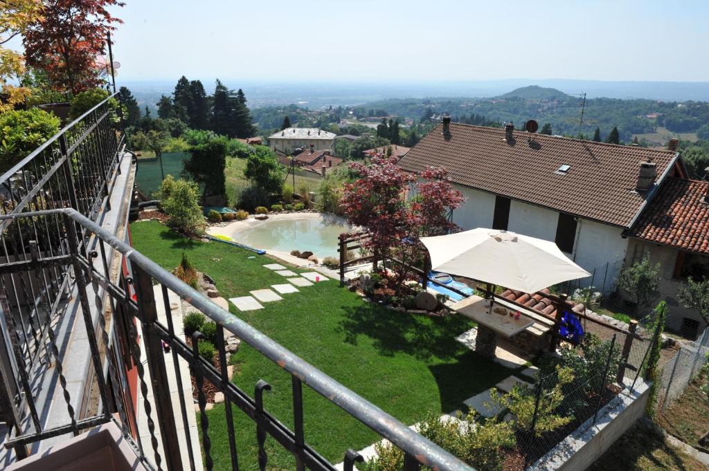 a view from the balcony of a house with a swimming pool at Affittacamere Belvedere in Sordevolo