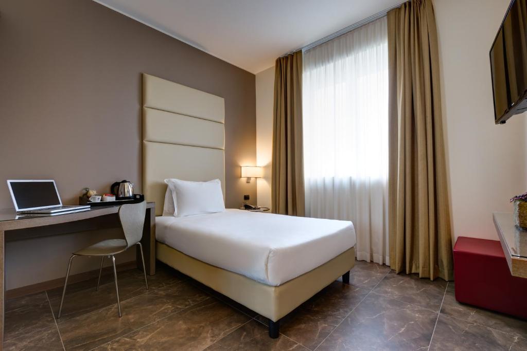 Postel nebo postele na pokoji v ubytování Klima Hotel Milano Fiere