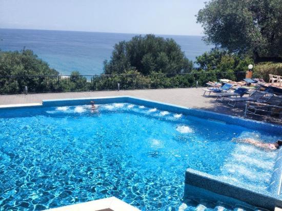 a large swimming pool with a view of the ocean at Villaggio Turistico La Fenosa in Marina di Camerota