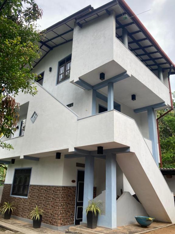 a white building with a spiral staircase on it at Penthouse Galle in Galle