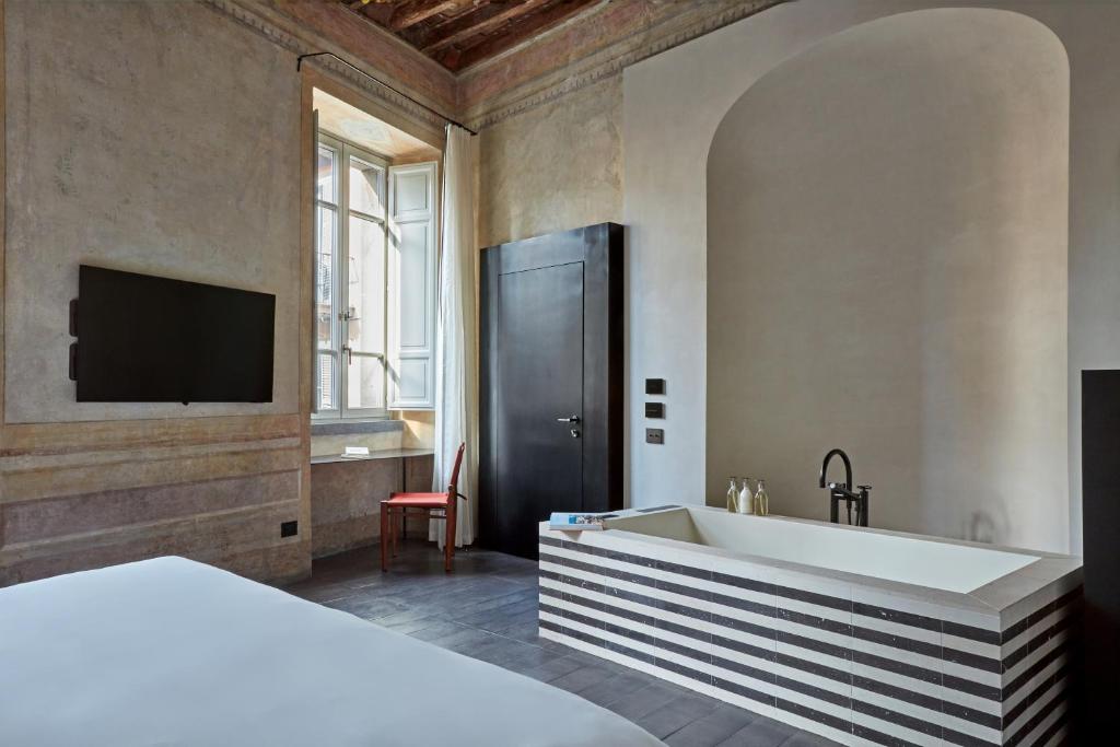 Postel nebo postele na pokoji v ubytování Palazzo Petrvs