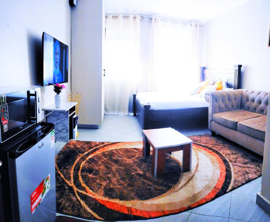 a living room with a couch and a coffee table at Essik Homes Studio 1 - Muthiga, Waiyaki Way in Nairobi