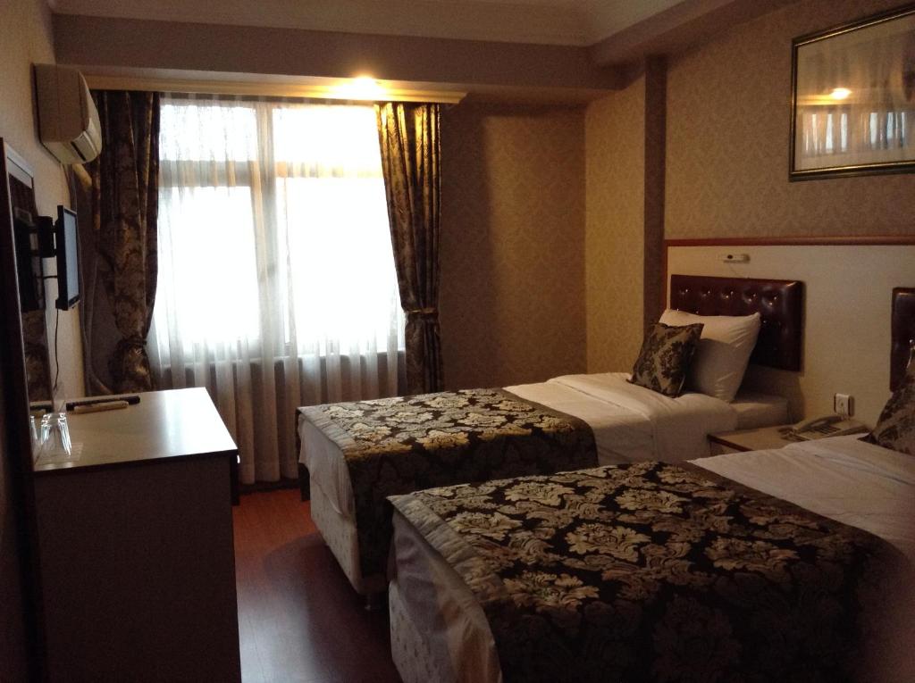 Ліжко або ліжка в номері Tayhan Hotel