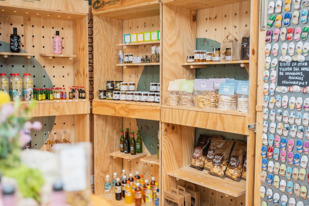 a store with wooden shelves filled with bottles and jars at Minura Sur Menorca in Punta Prima
