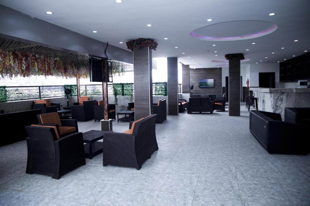 a lobby with couches and chairs in a building at SkyLine View Hotel in Mama