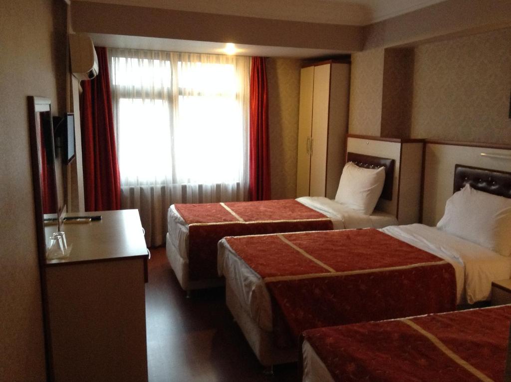 Ліжко або ліжка в номері Tayhan Hotel