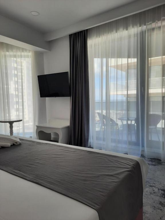 Postel nebo postele na pokoji v ubytování Hotel Simona Halep - Mamaia Nord