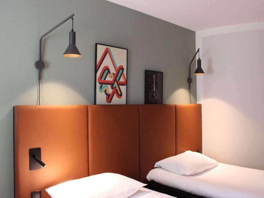 Кровать или кровати в номере ibis Bayeux Port En Bessin