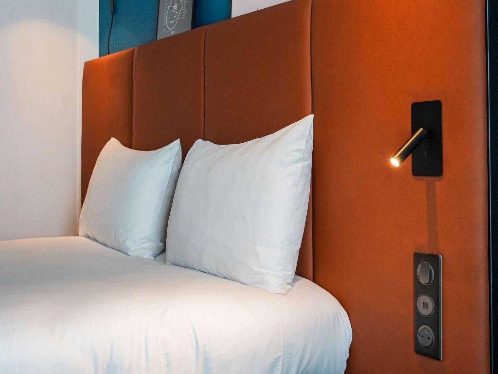 Кровать или кровати в номере ibis Bayeux Port En Bessin