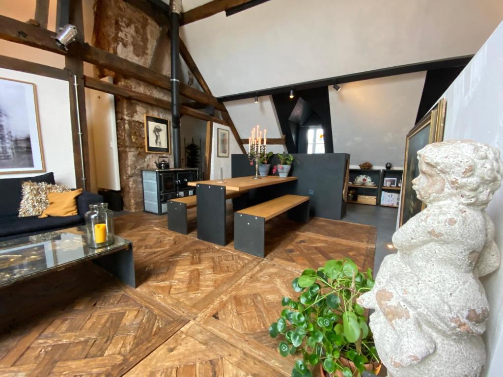 a living room with a statue in the middle of the room at The Castle Loft - Pascal's Angels in Clemency