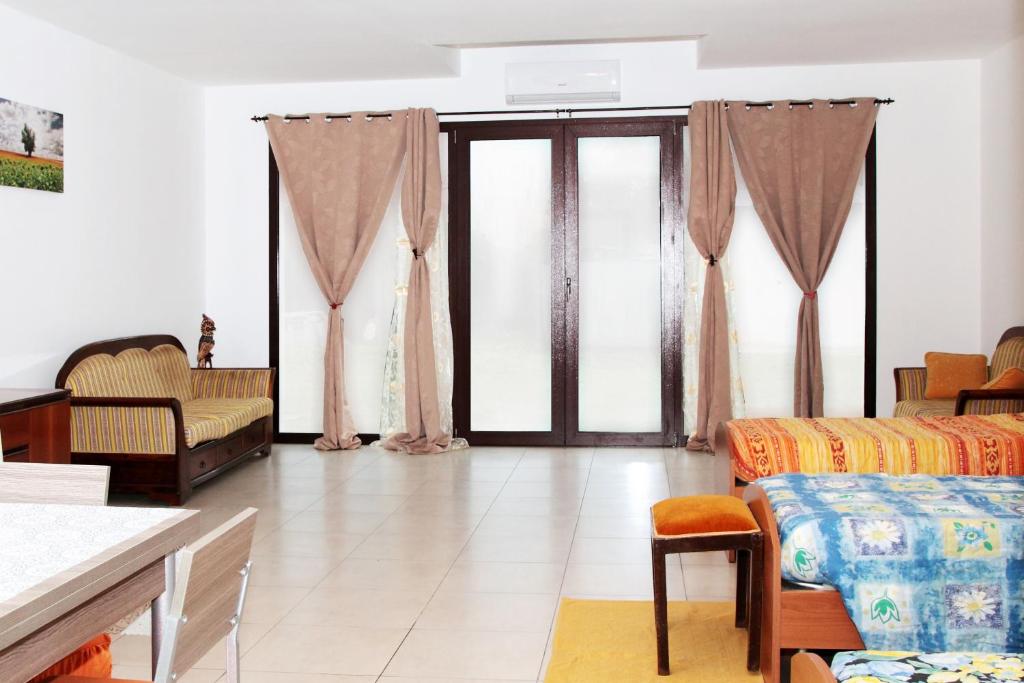 a living room with a couch and some windows at Valle Chiara in Ostellato