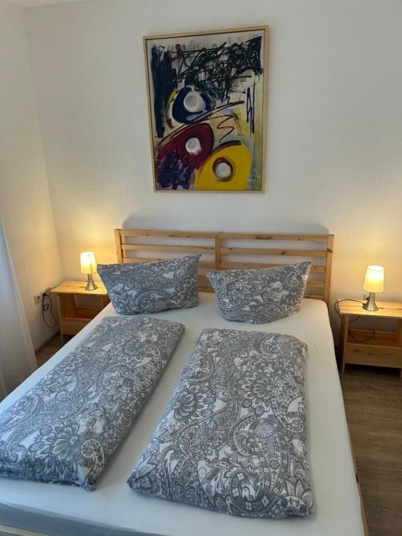 a bedroom with two beds and a painting on the wall at Ferienwohnung Truckses Schluchsee in Schluchsee
