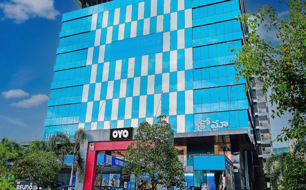 a tall glass building with a sign on it at Super Hotel O Botcha Convection in Visakhapatnam