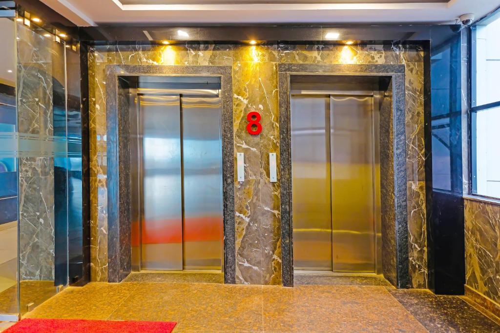 two elevators in a subway station with a red door at Super Hotel O Botcha Convection in Visakhapatnam