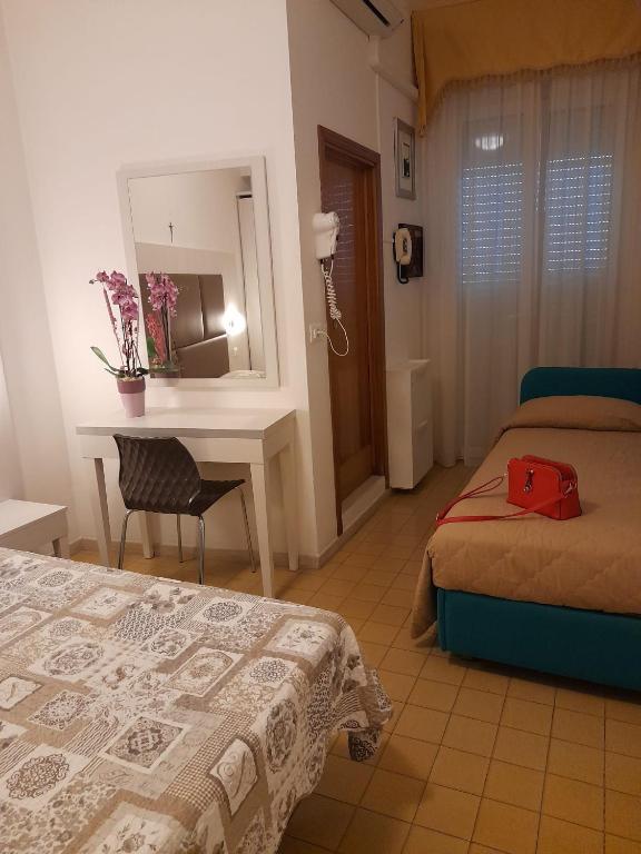 Postel nebo postele na pokoji v ubytování Hotel Gigliola