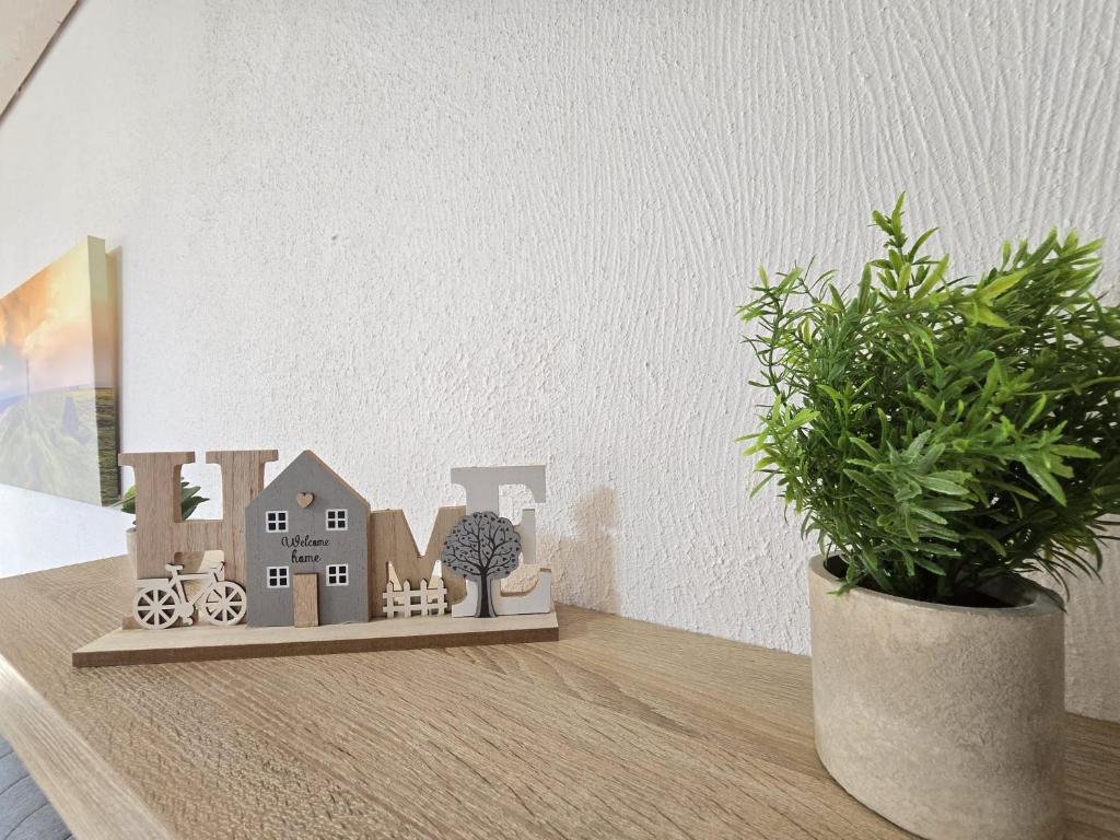a shelf with a house and a potted plant at Ferienwohnung Kajüte 4 in Norden
