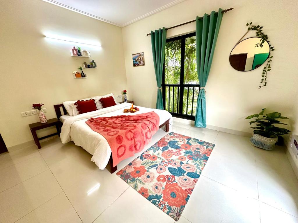 a bedroom with a bed and a window and a rug at Colorato By Sash Villas in Siolim