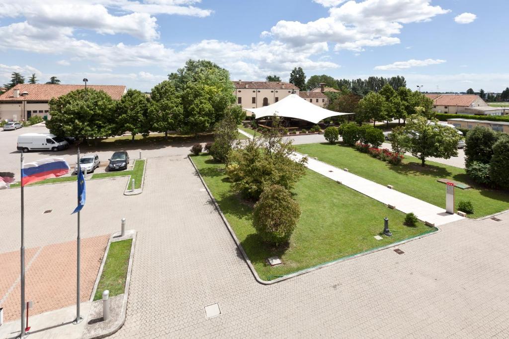 z góry widok na park z samochodami zaparkowanymi na parkingu w obiekcie UNA HOTELS Occhiobello w mieście Occhiobello