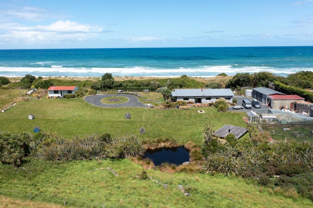 an aerial view of a house and the ocean at Southern Lights Retreat - Main House in Dunedin