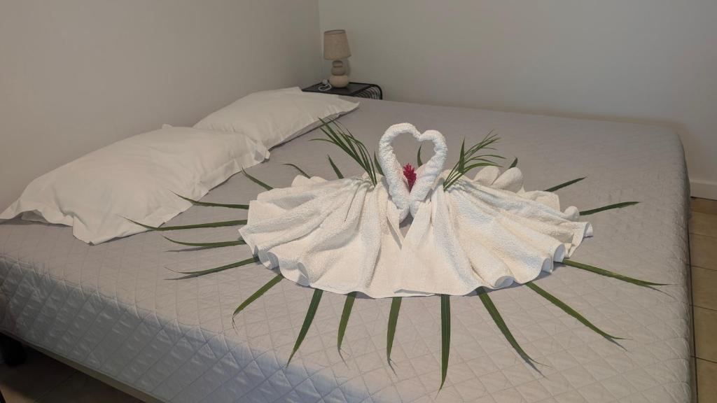 a bed with a white swan decoration on it at Enjoy Studio in Pointe-Noire