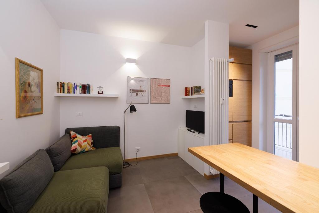 a living room with a couch and a table at H7 in Lido di Ostia