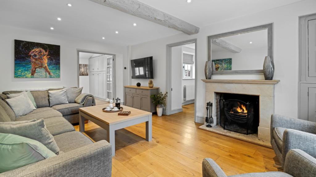 a living room with a couch and a fireplace at Vine Cottage in Campden Station