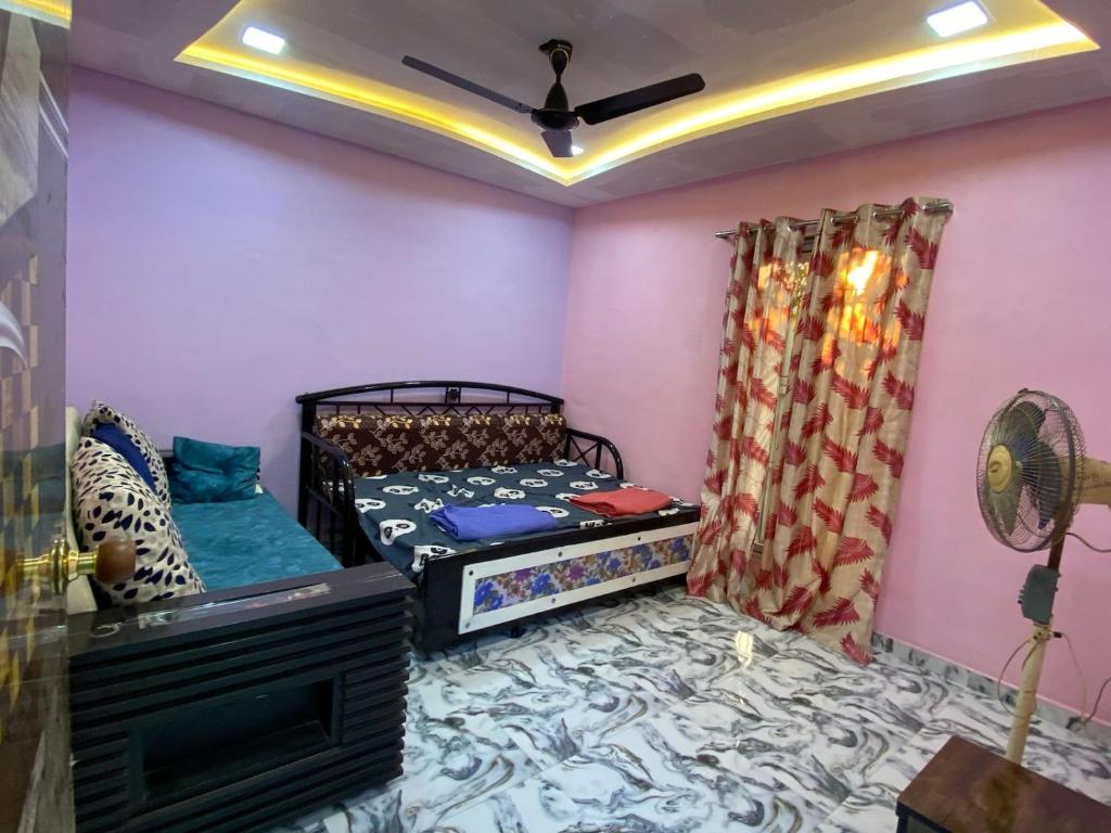 a bedroom with a bed and a tv in a room at Private Room At Sai Sanis Villa Ghodbender Road Kasarvadavali Thane West in Kolshet