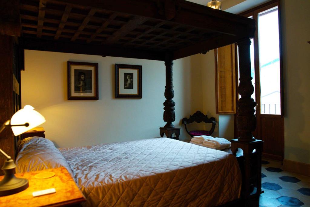 a bedroom with a canopy bed and a lamp at The Poets' Retreat in Sulmona