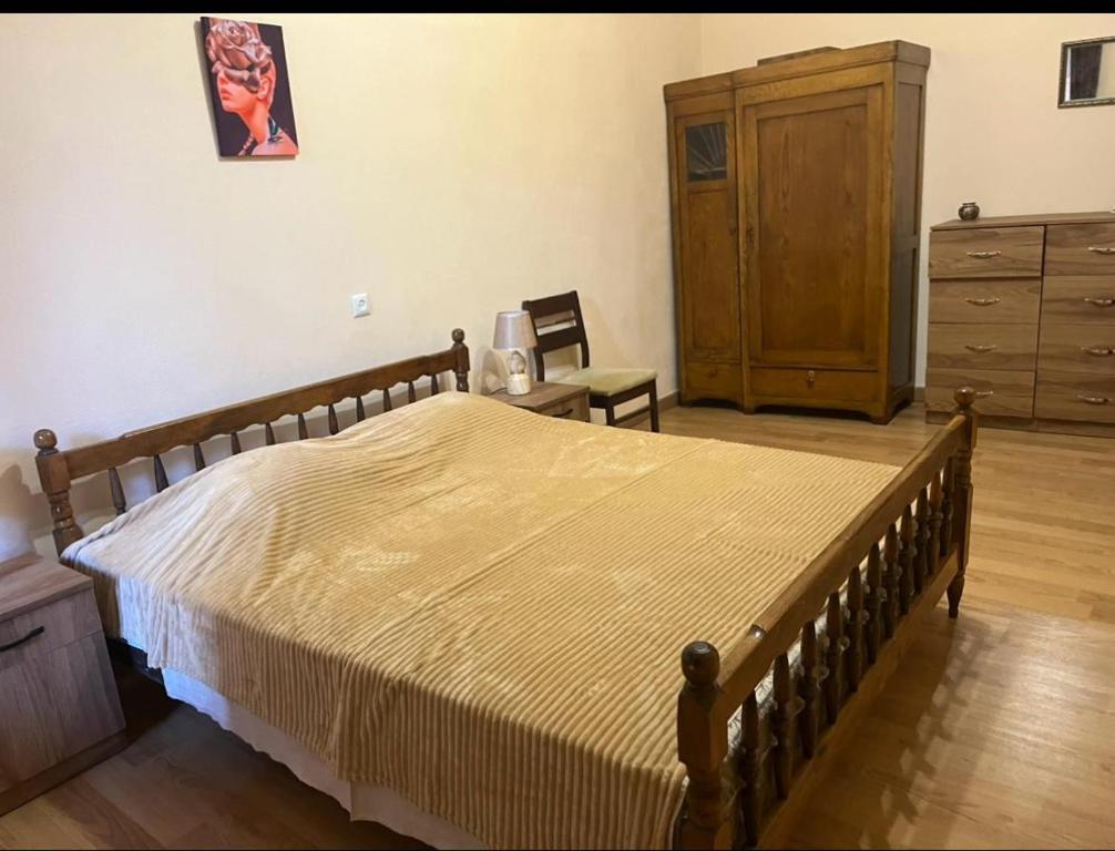 Un dormitorio con una cama grande con una cómoda y un tocador. en Apartment In City Center, en Tiflis