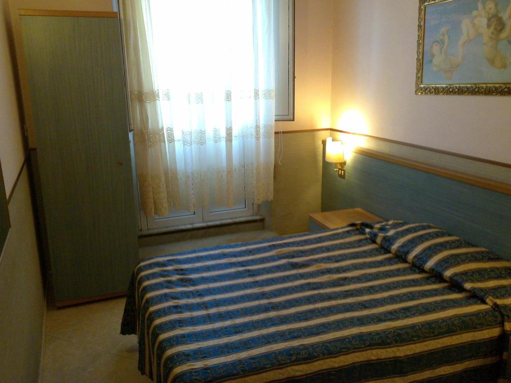 Postel nebo postele na pokoji v ubytování Hotel Lazzari