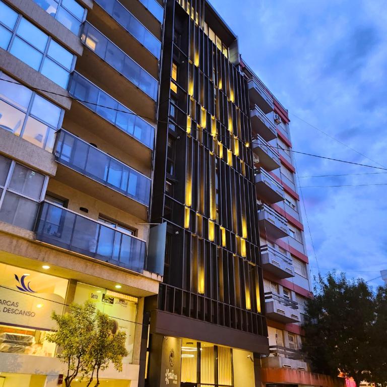 a tall building with a lot of windows at Hotel Estilo MB - Mar del Plata in Mar del Plata