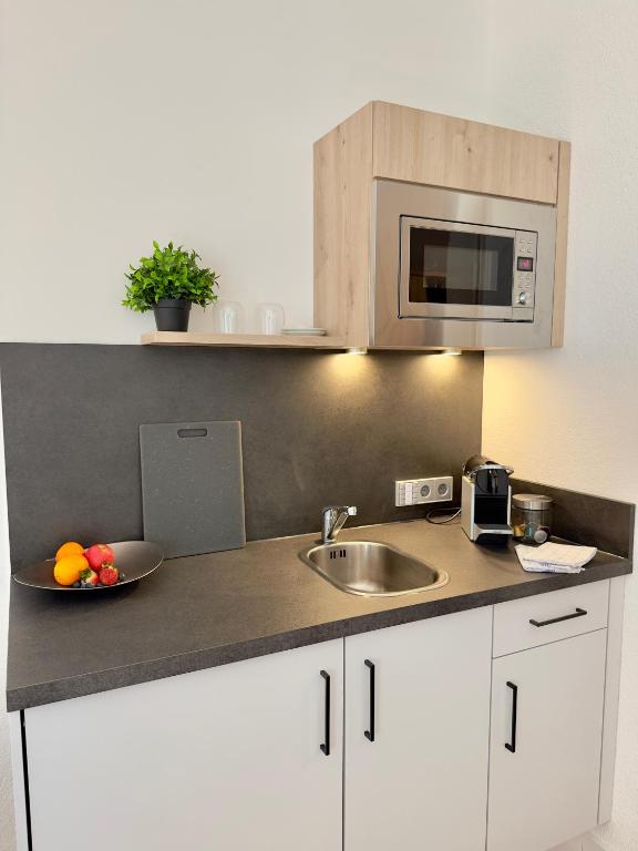Kuchyň nebo kuchyňský kout v ubytování Living & Serviced Apartments by Blauer Wolf