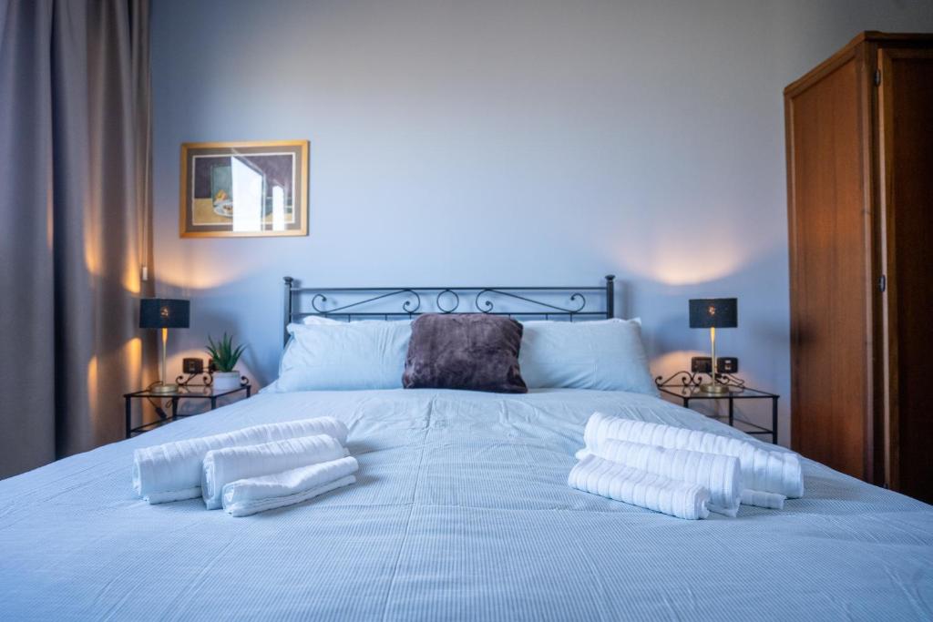 a white bed with two pillows on top of it at Camere Comfort - Locanda CasaMerlò in Sacerno