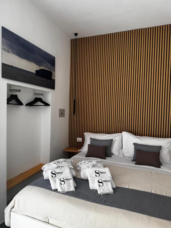 a bedroom with a large bed with towels on it at Scugnizzo Apartment in Naples