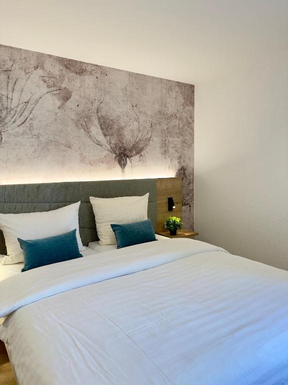 Postel nebo postele na pokoji v ubytování Living & Serviced Apartments by Blauer Wolf