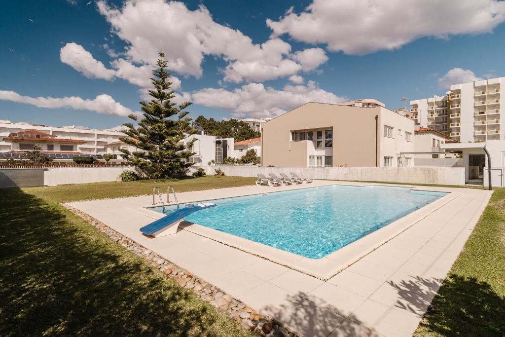 a swimming pool in the backyard of a house at Viana Beach Surf House in Viana do Castelo