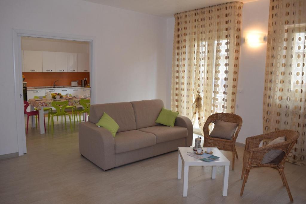 a living room with a couch and chairs and a table at Casa Vacanza Comfort in Ceglie Messapica