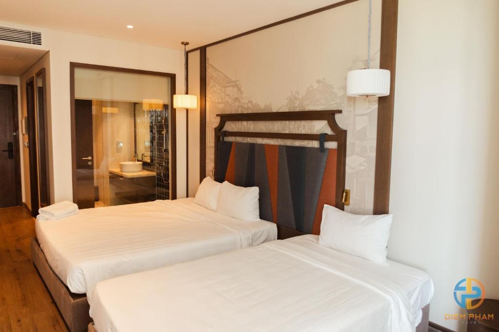 Giường trong phòng chung tại Apec Mandala Cham Bay Mui Ne - Ruby Apartment