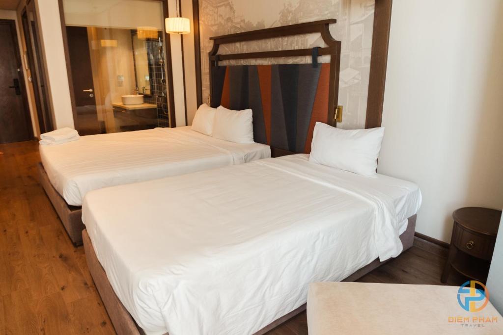 Giường trong phòng chung tại Apec Mandala Cham Bay Mui Ne - Ruby Apartment