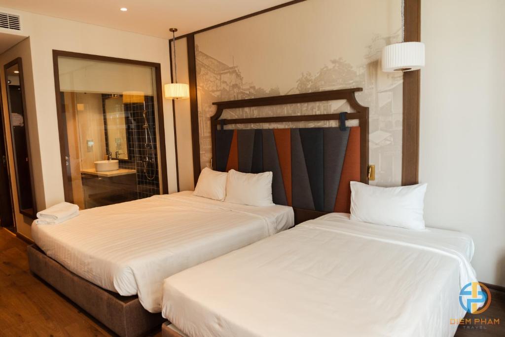 Giường trong phòng chung tại Apec Mandala Cham Bay Mui Ne - Ruby Apartment