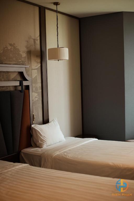 Giường trong phòng chung tại Apec Mandala Cham Bay Mui Ne - Ruby Apartment